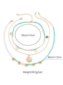 Collana con 3 pezzi di perle finte a motivo sole e fiori