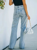 Pantaloni in denim lavato con spacco all'orlo