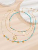 Collana con 3 pezzi di perle finte a motivo sole e fiori