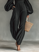 Dame off-shoulder jumpsuit med lange ærmer og plisseret stof